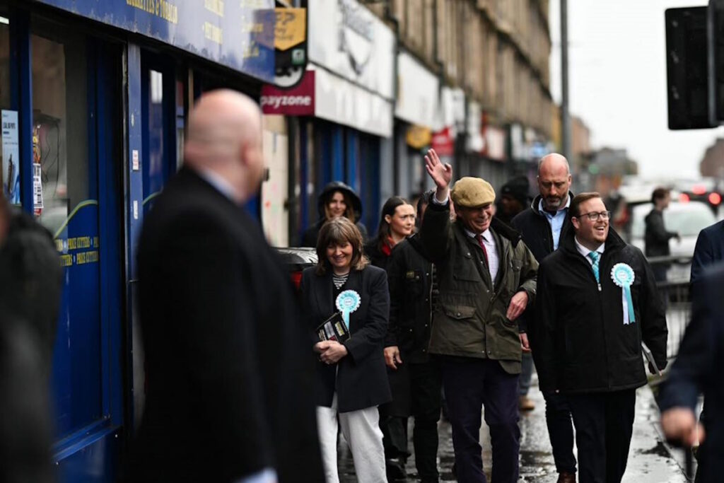 Nigel Farage walking down Shettleston street with Thomas Kerr