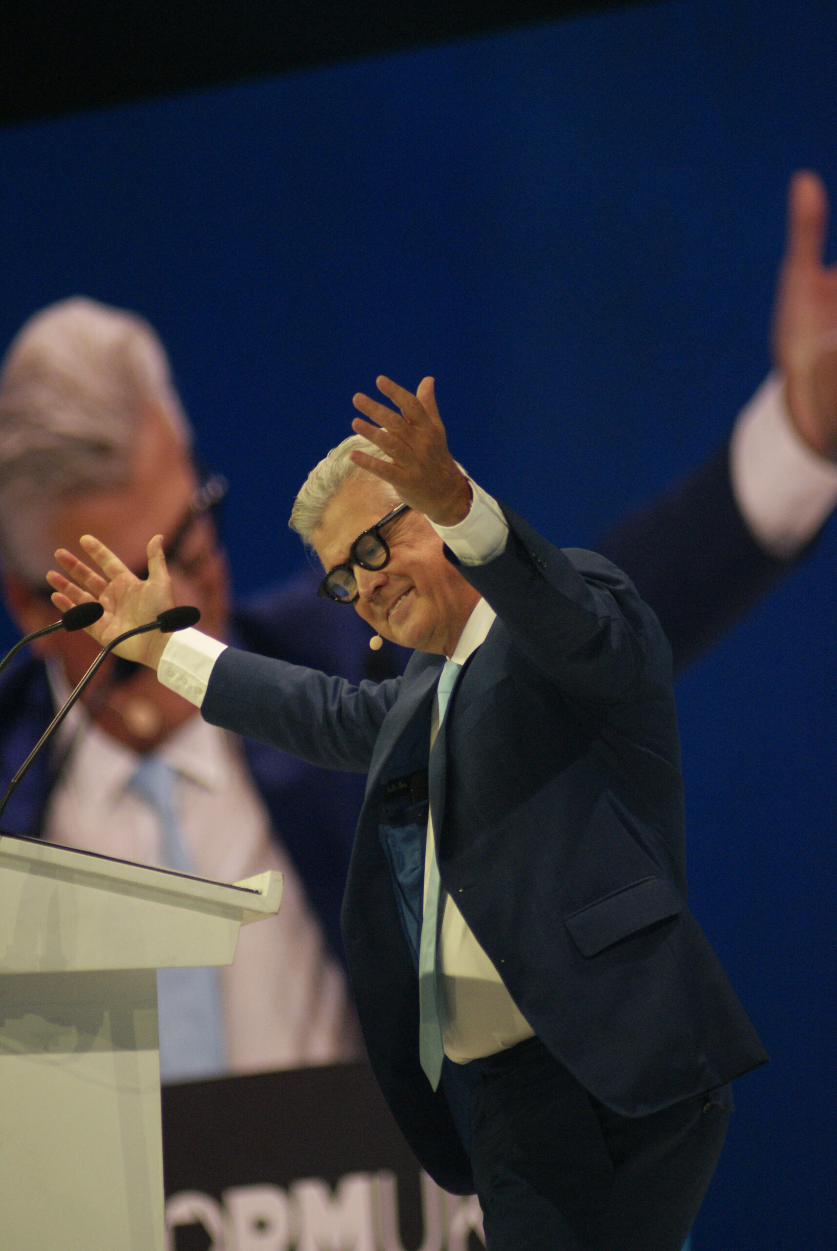 Malcolm Offord addresses Reform UK Conference 2026 from the stage beneath The First 100 Days branding.