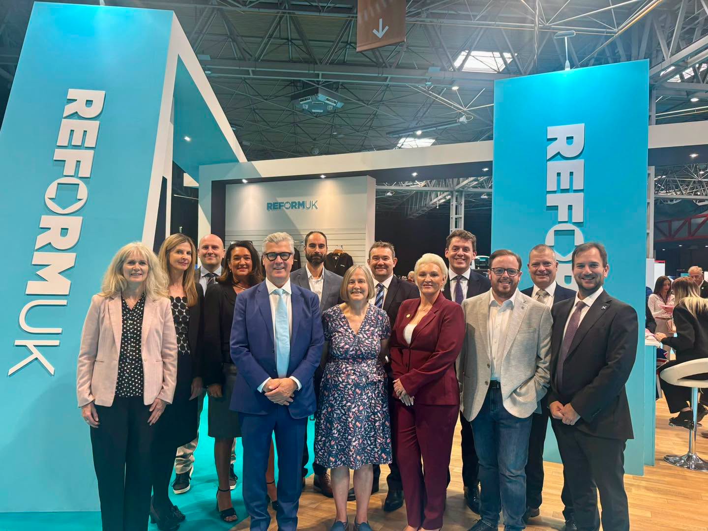 Reform UK Scotland MSPs and representatives pose at the Reform UK exhibition stand at Conference 2026.